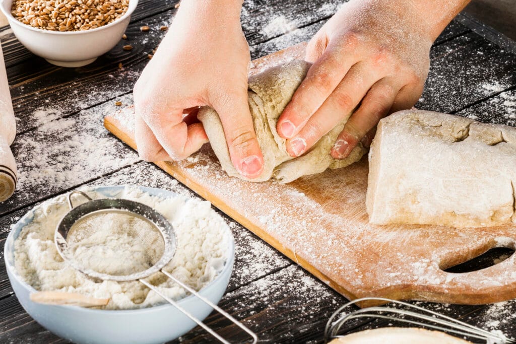 A loaf of freshly baked homemade bread on a wooden cutting board