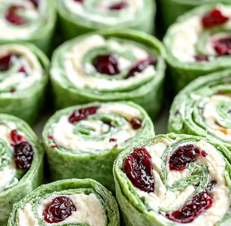 Plate of festive Christmas Cranberry Pinwheels ready for holiday serving.