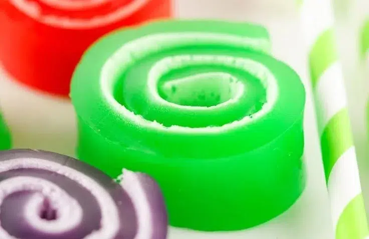 Colorful gelatin roll-ups on a plate, inspired by viral TikTok trends.