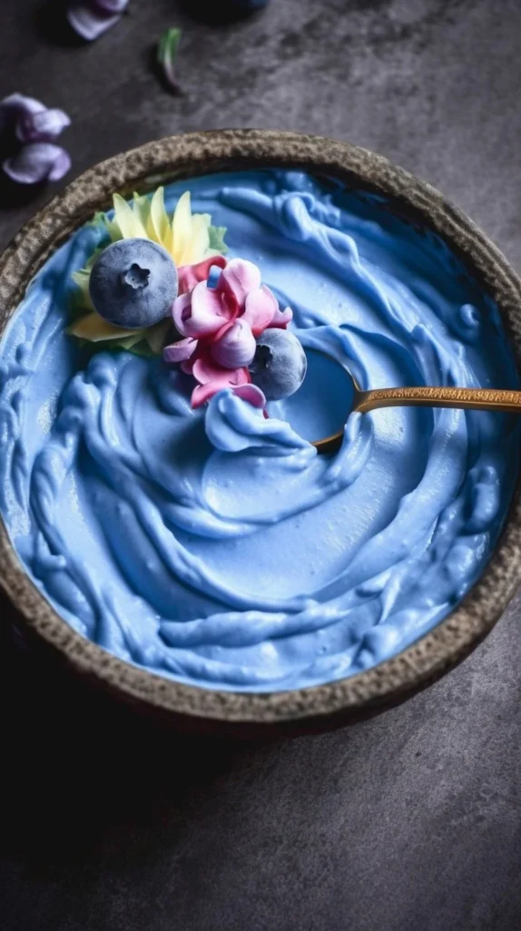 Blue Coconut Smoothie Bowl topped with fruits and coconut flakes.