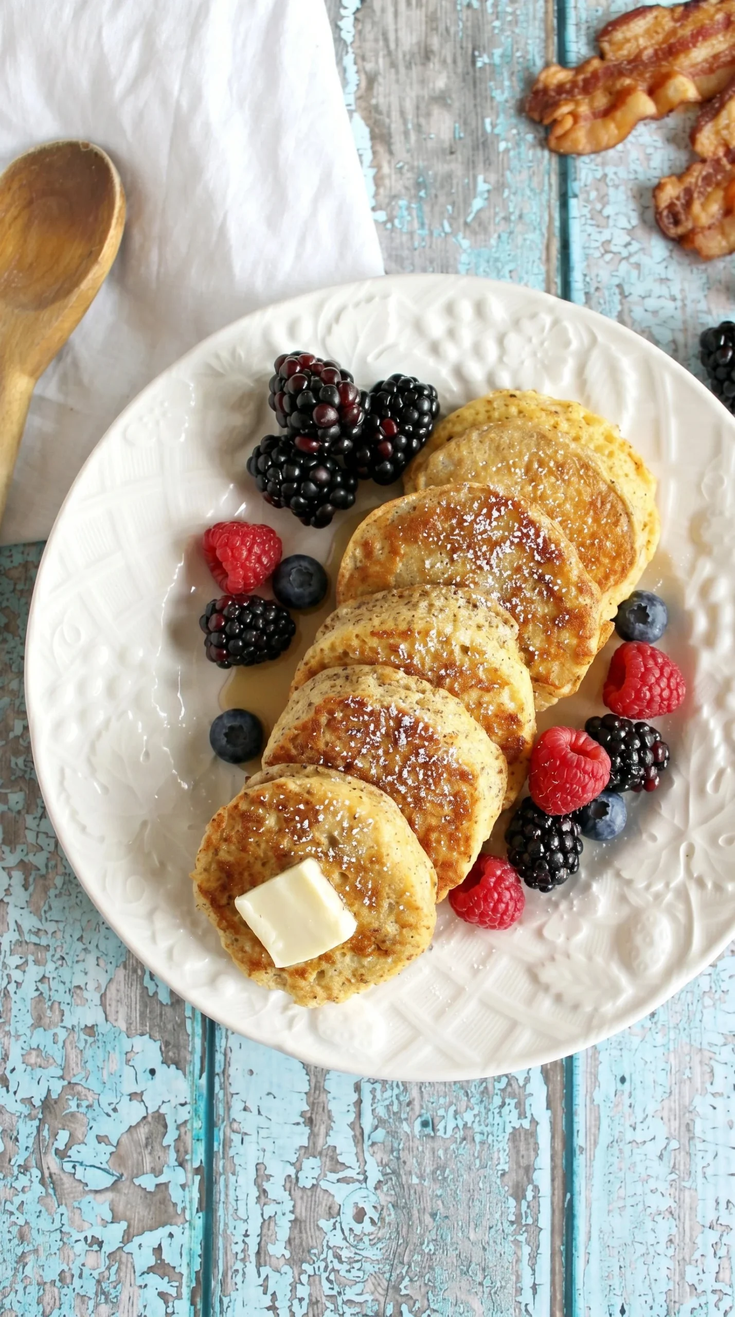 A delicious plate of Keto French Toast topped with berries and whipped cream