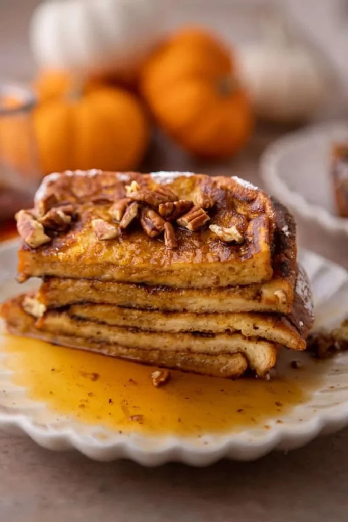 Deliciously cooked Pumpkin French Toast served with syrup and whipped cream