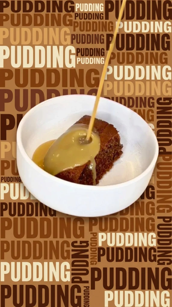 Delicious sticky date pudding served with caramel sauce and cream